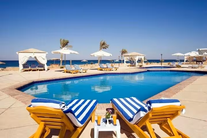 Resort pool with sunbeds and sea view on El Ain El Sokhna day tour from Cairo, Red Sea getaway