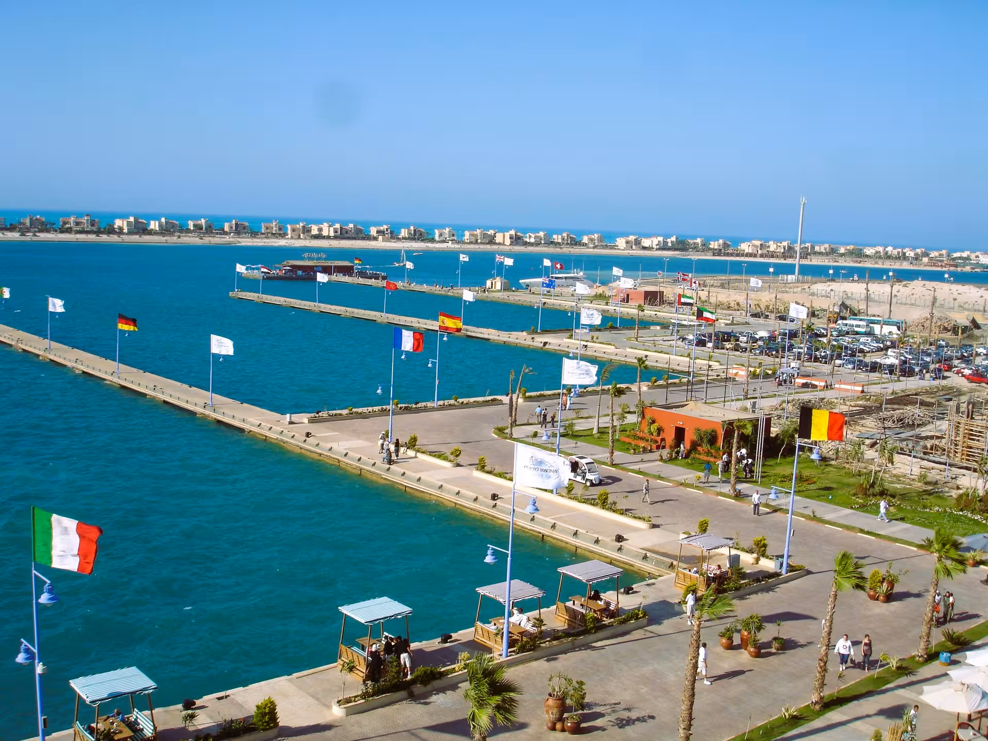 El Alamein harbor marina with European flags and turquoise Mediterranean Sea, Egypt