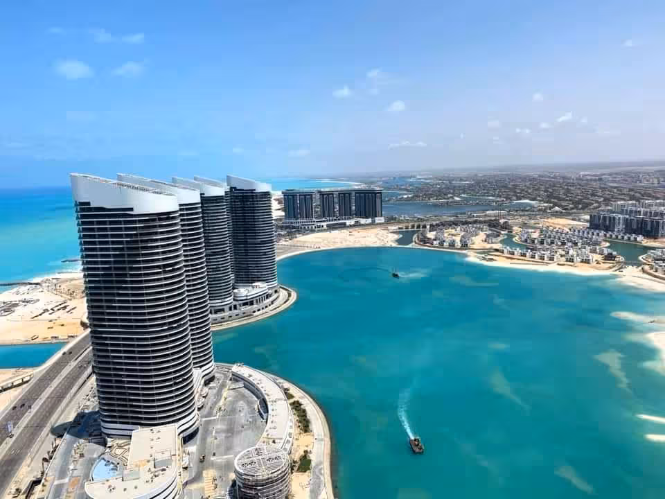 Aerial view of El Alamein modern towers and turquoise lagoon on Egypt's Mediterranean coast
