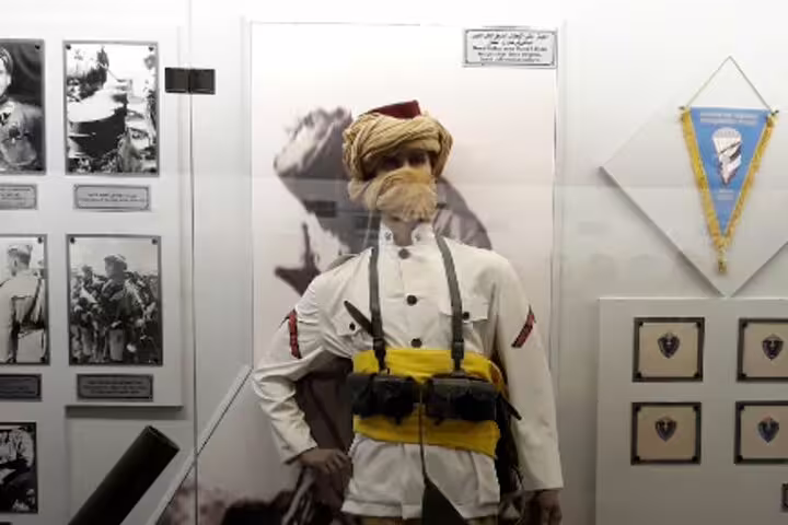 Desert soldier uniform exhibit inside El Alamein War Museum, highlight of El-Alamein day trip from Cairo