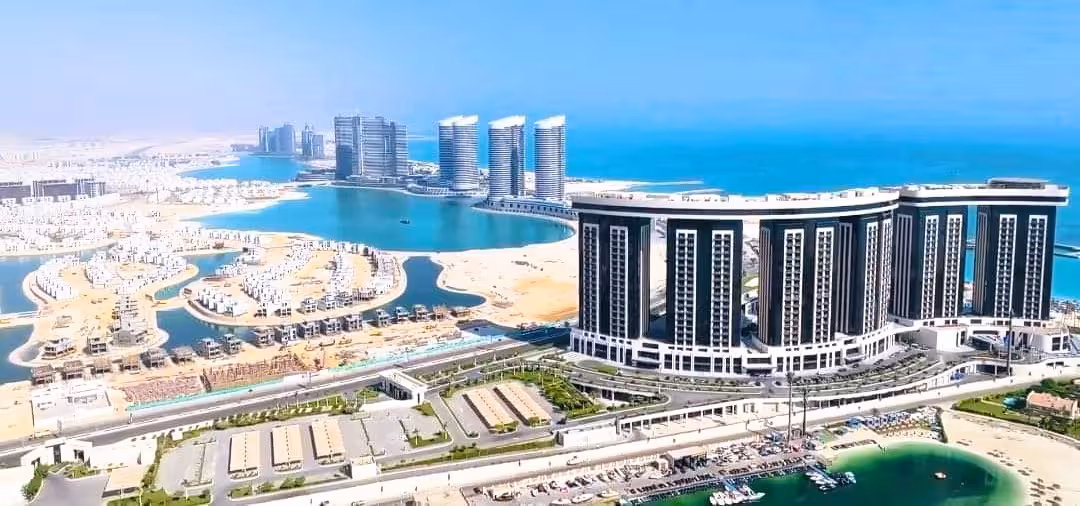 Aerial view of El Alamein modern waterfront city with blue Mediterranean Sea and luxury towers