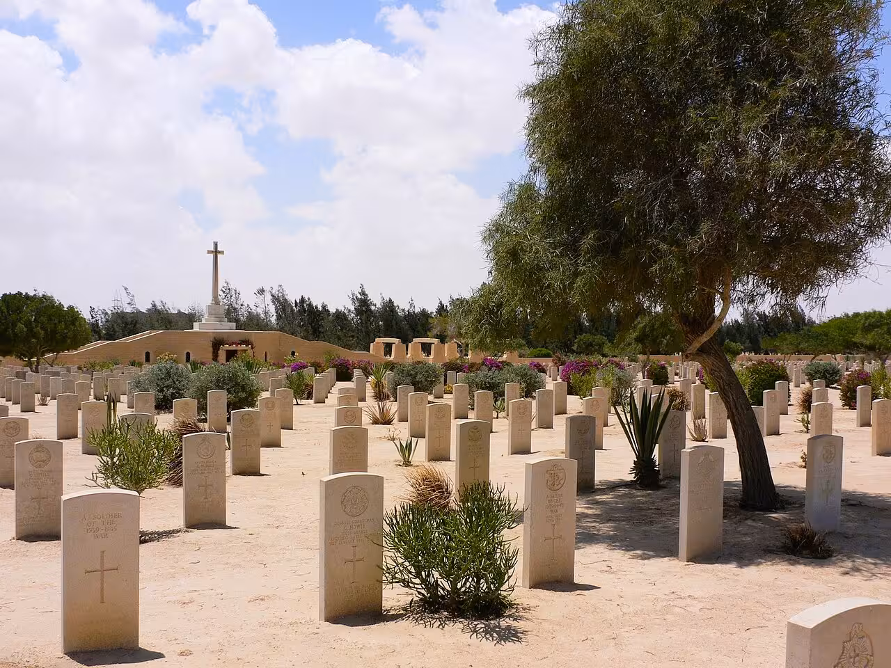 El Alamein WWII Commonwealth War Cemetery with rows of white headstones and cross memorial, Egypt