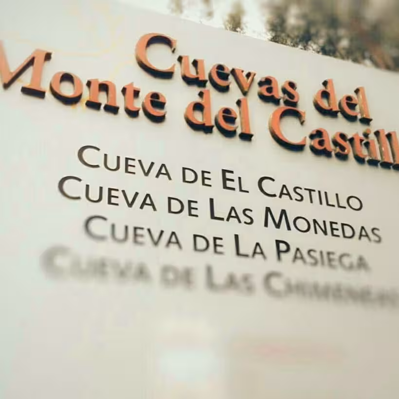 Entrance sign for Cuevas del Monte del Castillo highlighting El Castillo and other notable caves.