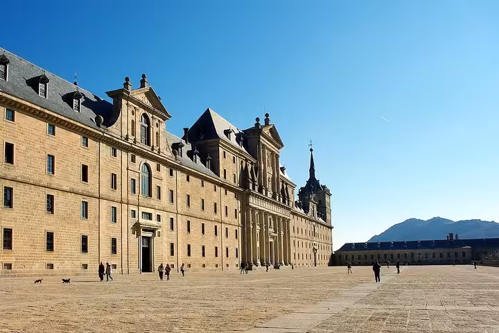 Explore the vast courtyard of El Escorial under a clear blue sky on this half-day morning tour from Madrid.
