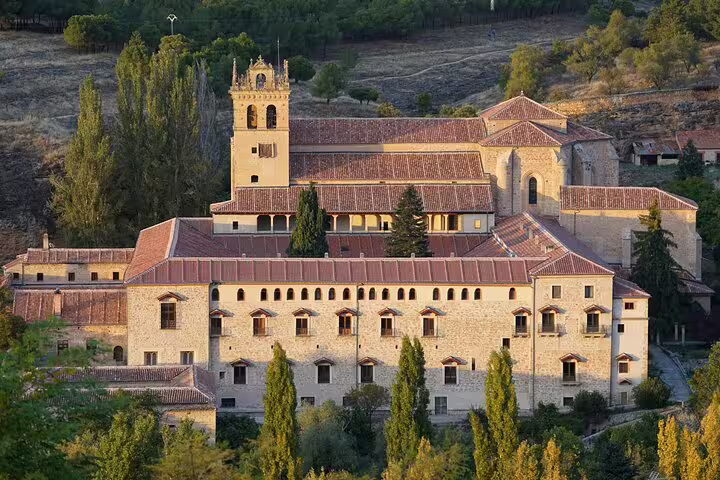 El Escorial Monastery exterior with stone walls and bell tower, scenic highlight on private minivan day trip