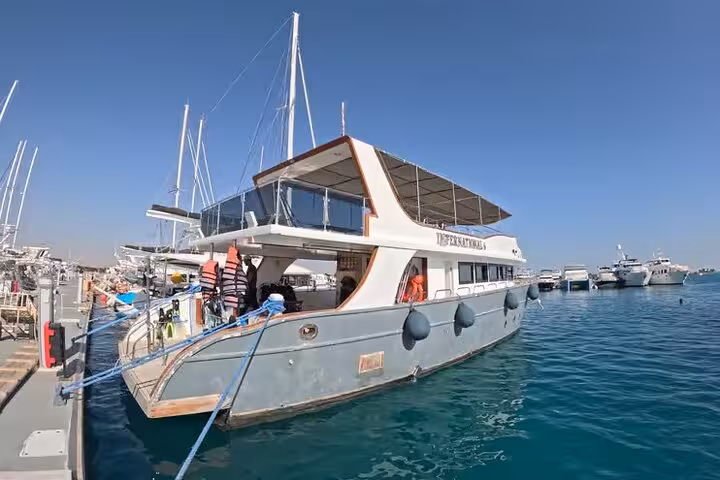 El Gouna marina dive boat ready for Red Sea lagoon snorkeling and dolphin encounter tour, with onboard lunch