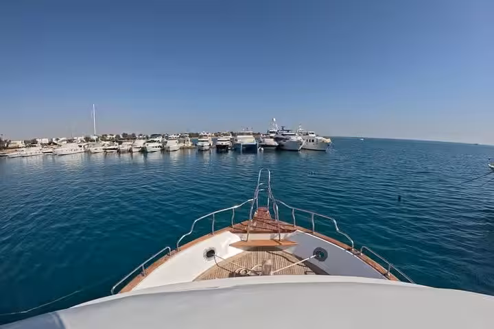 Boat departing El Gouna marina across the Red Sea lagoon for dolphin snorkeling, diving trip and lunch cruise