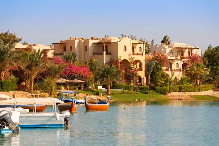 El Gouna lagoon waterfront villas, palm trees and boats, scenic stop on private half-day city tour cruise