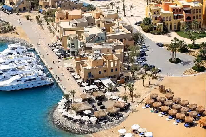 Aerial view of El Gouna waterfront promenade, yachts and beach huts on a private half-day city tour and lagoon cruise