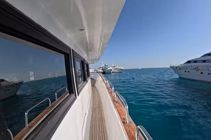 View along a yacht deck cruising the Red Sea from El Gouna marina, heading to lagoon snorkeling and dolphin dive