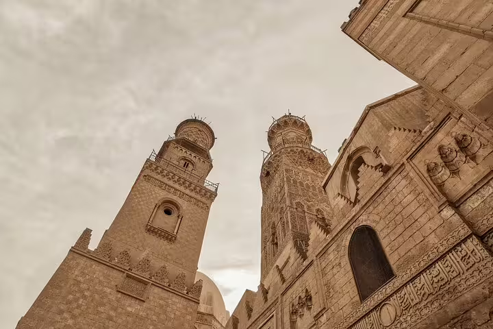 Mamluk minarets and carved stone facade on El-Moez Street, Islamic Cairo tour with El-Fishawy Café