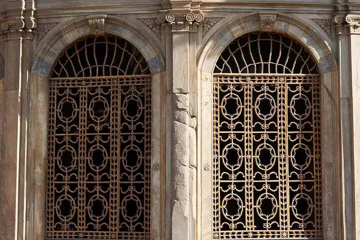 Ornate arched windows with wrought-iron grilles on El-Moez Street, Islamic Cairo heritage tour Egypt