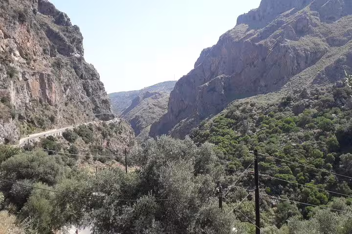 Scenic mountain view along the route to Elafonisi Beach on a private tour from Chania, showcasing lush greenery and rugged cliffs.