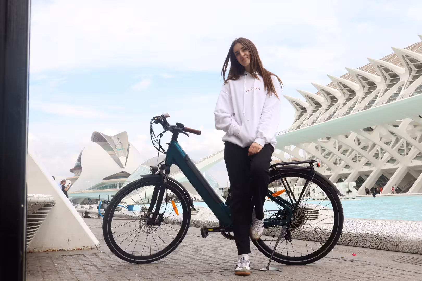 Traveler with electric bike rental at Valencia City of Arts and Sciences, perfect for scenic city cycling