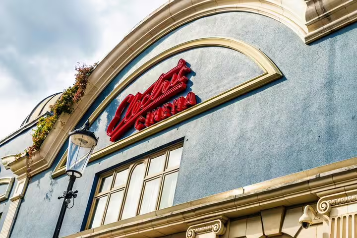 Electric Cinema red neon sign on blue facade in Notting Hill, London