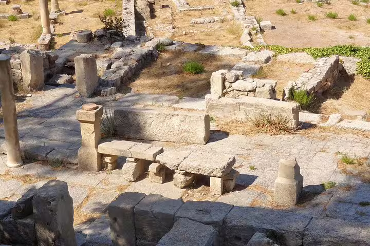 Ancient ruins at Eleftherna showcasing historical stone structures under a sunny sky, perfect for cultural exploration.