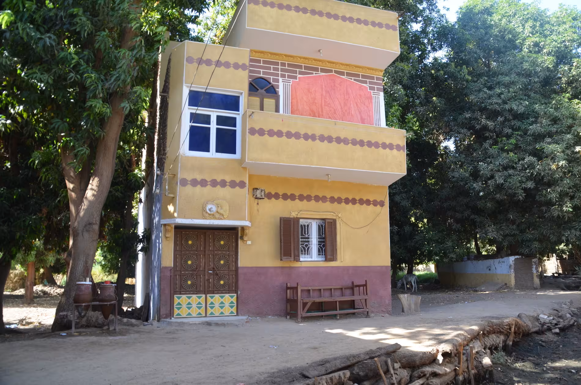 Colorful two-story yellow and purple Egyptian village house on Elephantine Island, Aswan