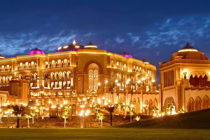Illuminated view of the luxurious Emirates Palace in Abu Dhabi at night during a 4x4 city tour from Dubai.