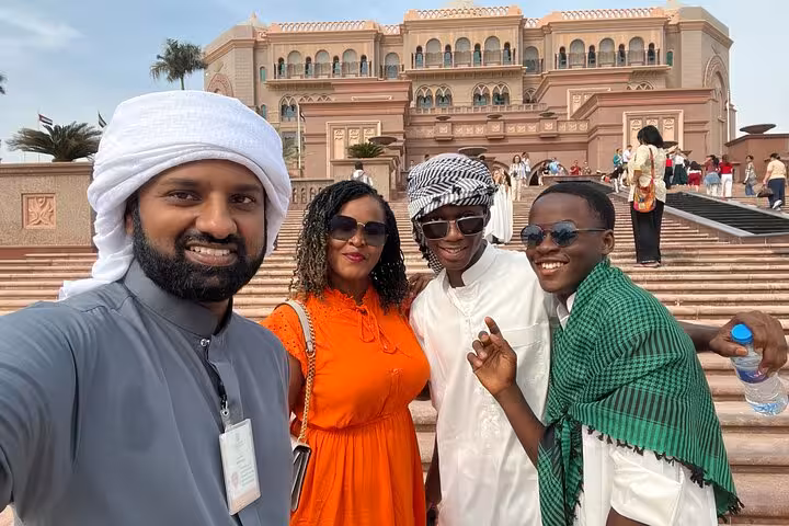 Travelers selfie at Emirates Palace Abu Dhabi during Dubai to Abu Dhabi multi-day adventure tour experience