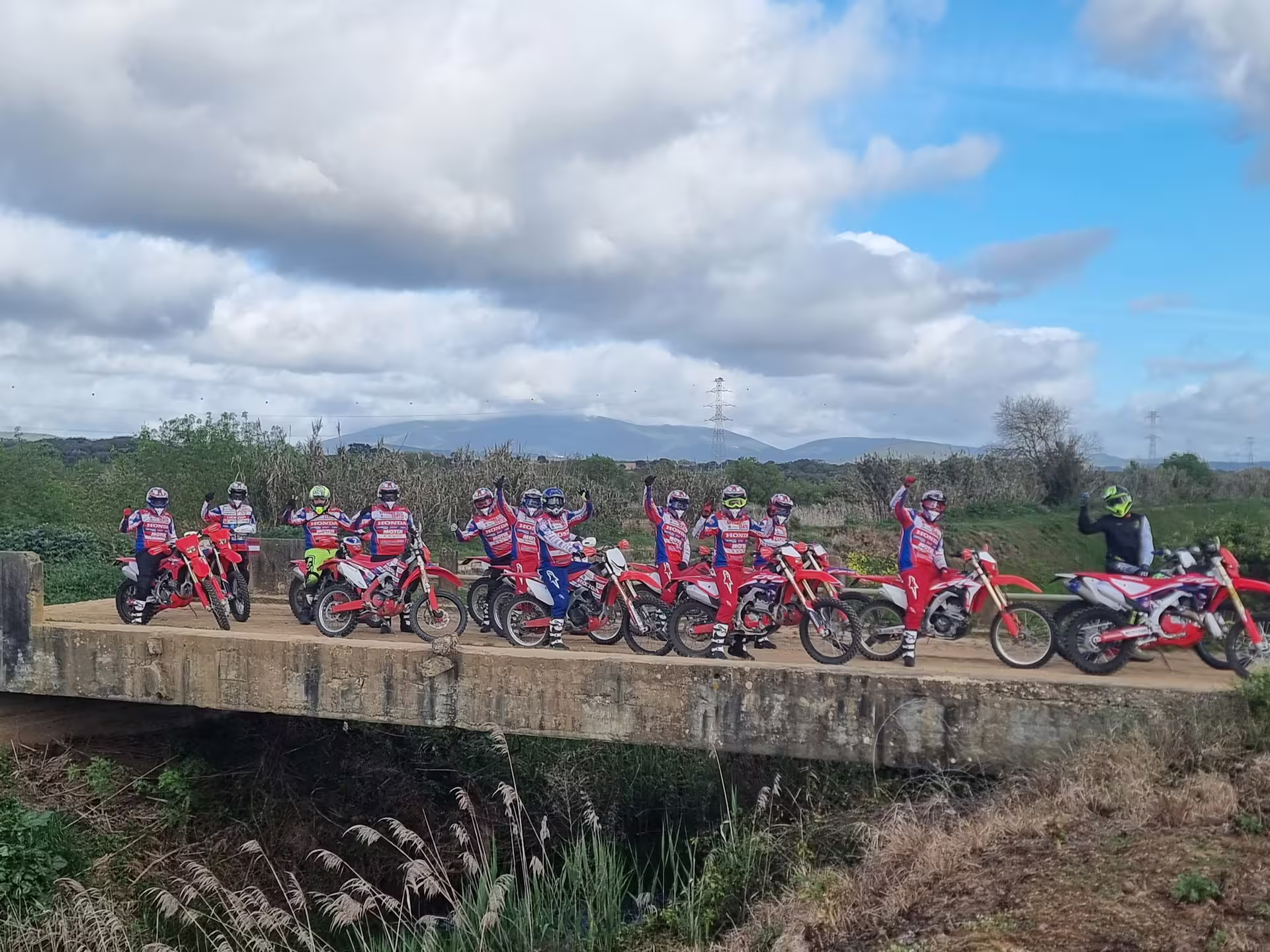 Enduro bikers on a bridge in Carregado, Lisbon, enjoying a thrilling 3-hour tour with stunning natural landscapes.