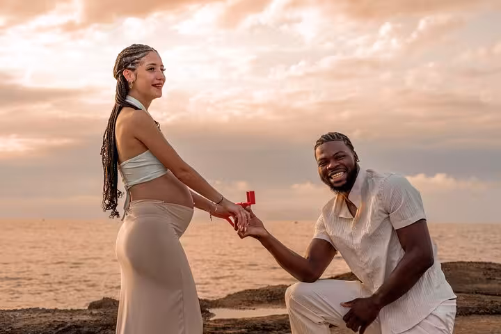 Joyful engagement moment by the sea captured during Analipsi photoshoot session.