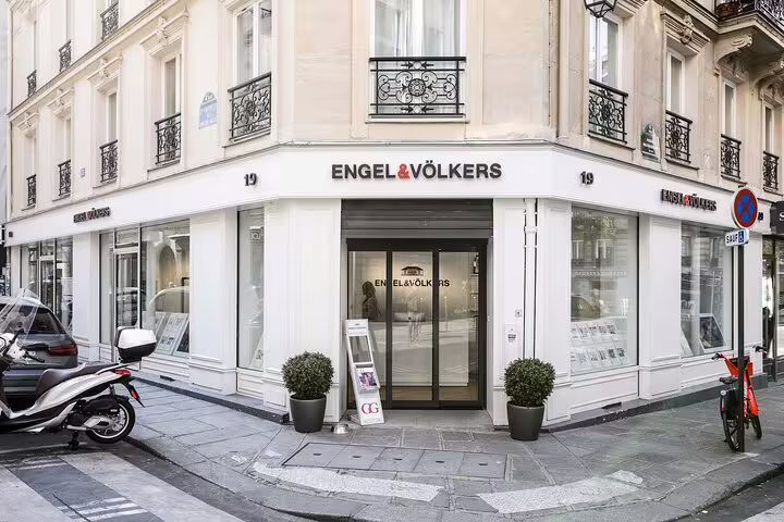 Engel & Völkers real estate office on a Parisian street corner with Haussmann-style building