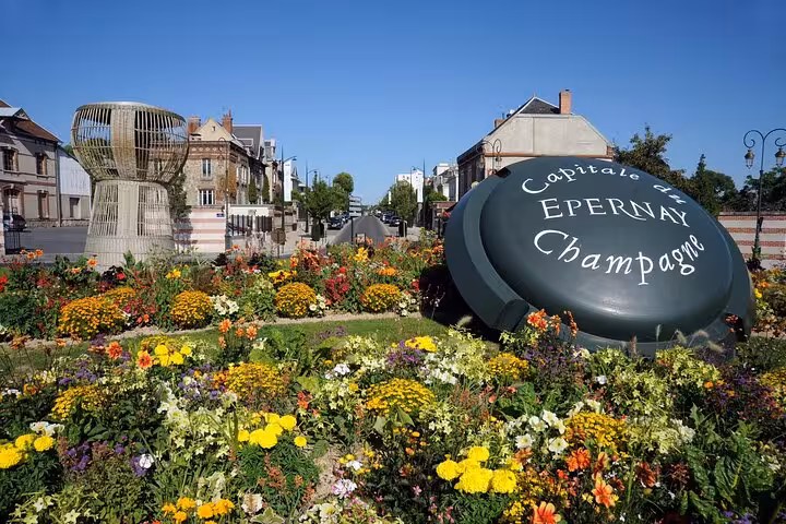 Epernay Champagne capital sign surrounded by colorful flowers in city center, France
