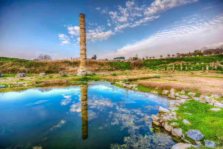 Ancient column reflection in water at Ephesus, perfect for a guided tour from Kusadasi Port.