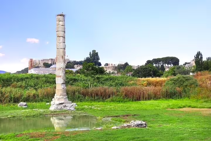 Ancient column remains at Ephesus under a clear sky, part of the skip-the-line tour from Kusadasi Port.