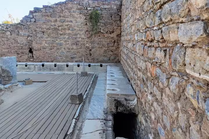 Ancient latrine ruins at Ephesus on 2-day mini group tour from Kusadasi with Pamukkale visit
