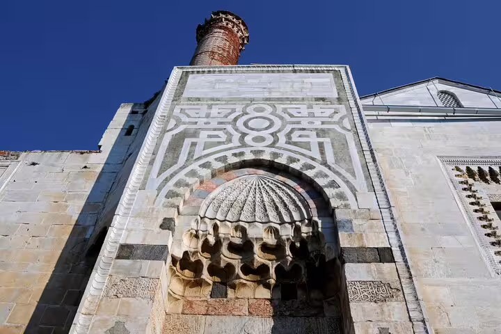 Intricate stonework and arch at a historic site in Ephesus, Turkey, showcasing ancient architectural details.