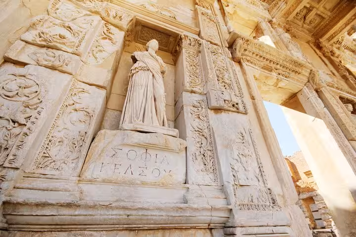 Close-up of carved reliefs and statue at Ephesus ruins on private Kusadasi Port tour, ancient details