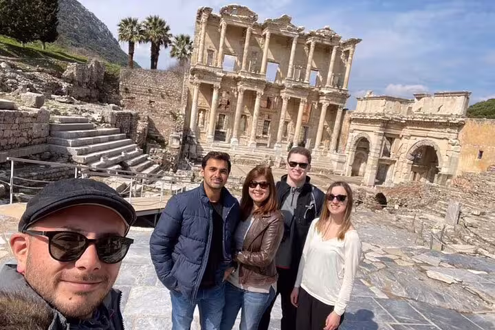 Visitors enjoying a guided tour at the historic Celsus Library in Ephesus, part of a half-day excursion from Kusadasi.