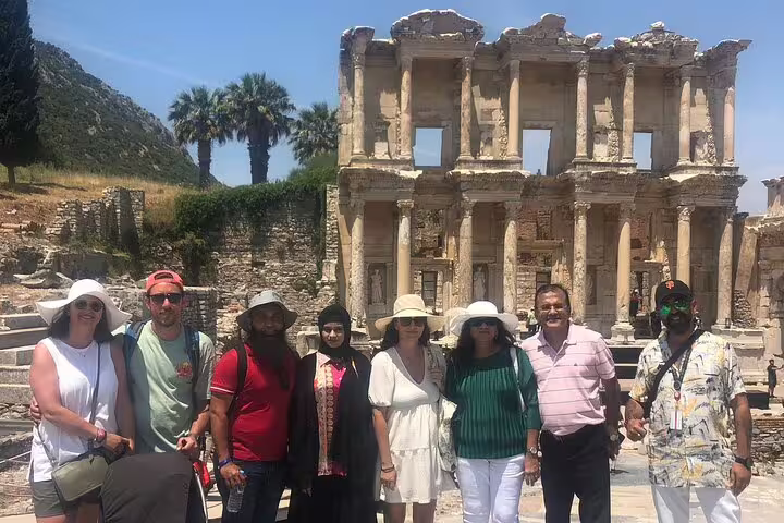 Tour group enjoying a visit to the historic Celsus Library in Ephesus on a half-day trip from Kusadasi hotels.