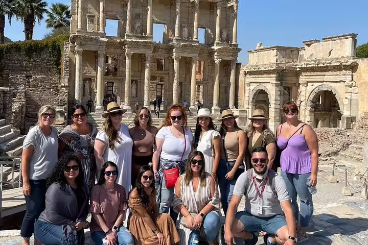 Tour group enjoying a sunny day at Ephesus' Celsus Library during 2-day tour from Istanbul.