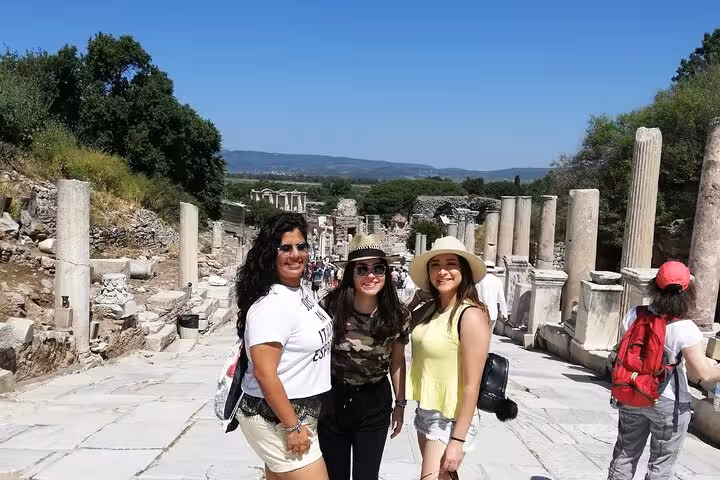 Cruise shore excursion at Ephesus Curetes Street, travelers posing among ancient columns in Turkey