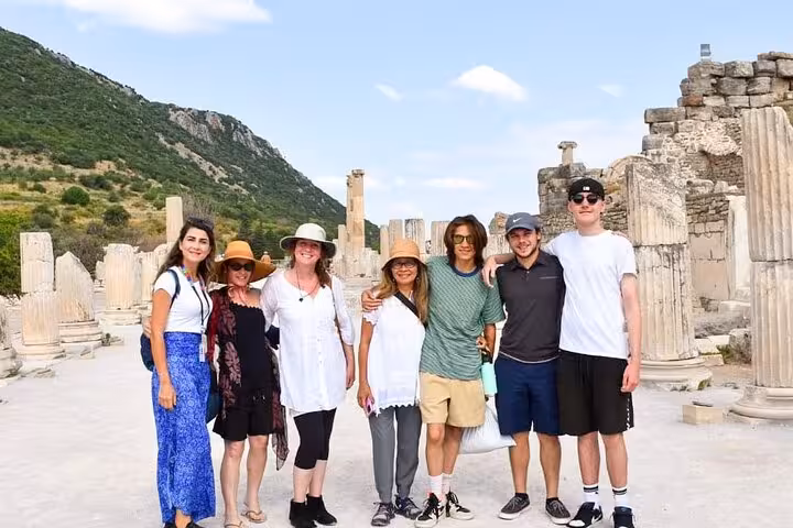 Private Ephesus tour from Kusadasi port with cruise guests posing among ancient ruins and columns
