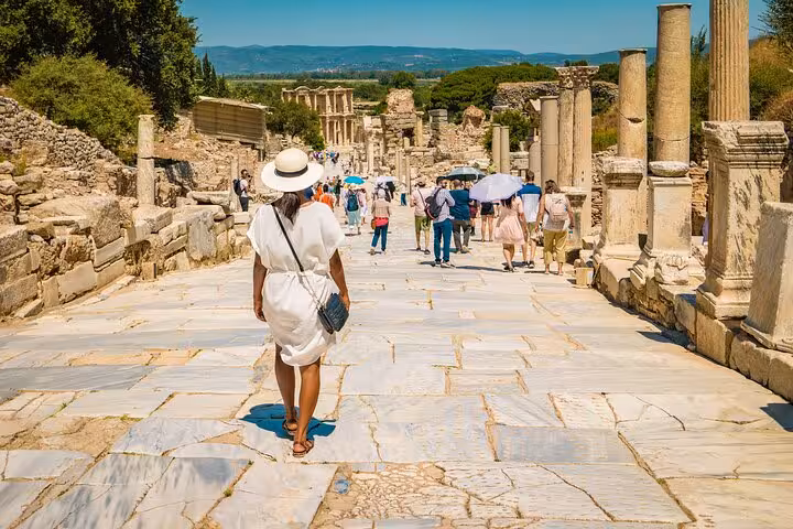 Tourists walking Curetes Street in ancient Ephesus on full-day tour from Selcuk and Kusadasi