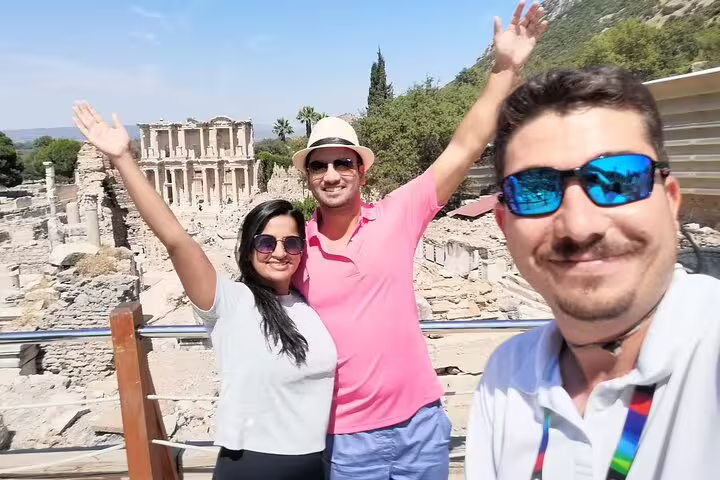 Guests pose at Ephesus viewpoint with Library of Celsus behind, private guided tour with no hidden fees