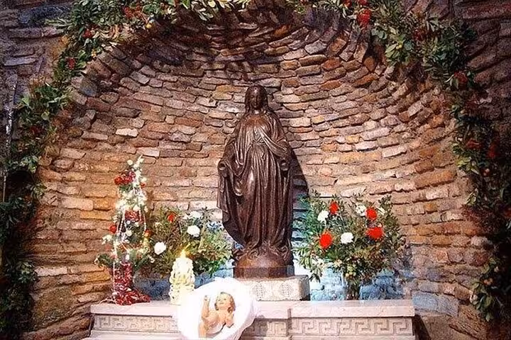 Shrine at House of Virgin Mary near Ephesus with statue and flowers, a key stop on cruiser Bible tour