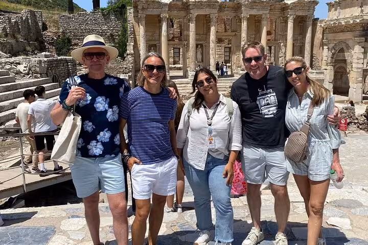 Cruise excursion photo at Ephesus with guide, guests posing by the Library of Celsus from Kusadasi port