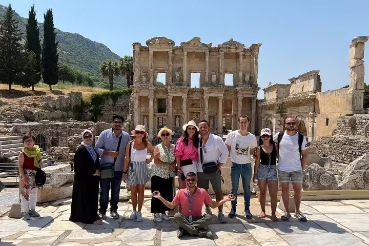 Group of tourists in front of the ancient Library of Celsus in Ephesus during a guided tour from Kusadasi and Selcuk.