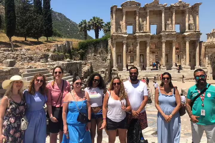 Tour group posing in front of the iconic Library of Celsus in Ephesus, vibrant stop on Izmir Port excursion.