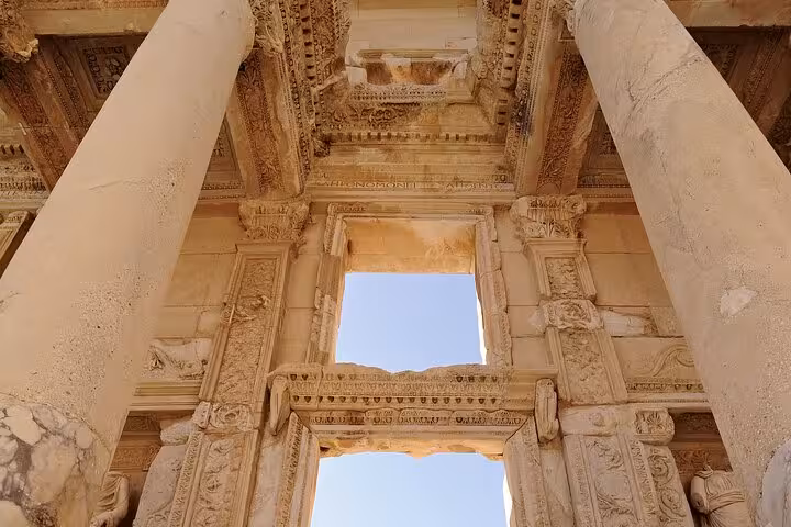 Ornate marble columns and carved arch at Ephesus ruins, highlight of Ephesus and Pamukkale tour from Istanbul