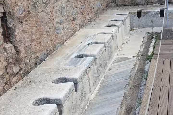 Ancient Ephesus marble public latrine seats on a private less-walking tour with Virgin Mary House visit