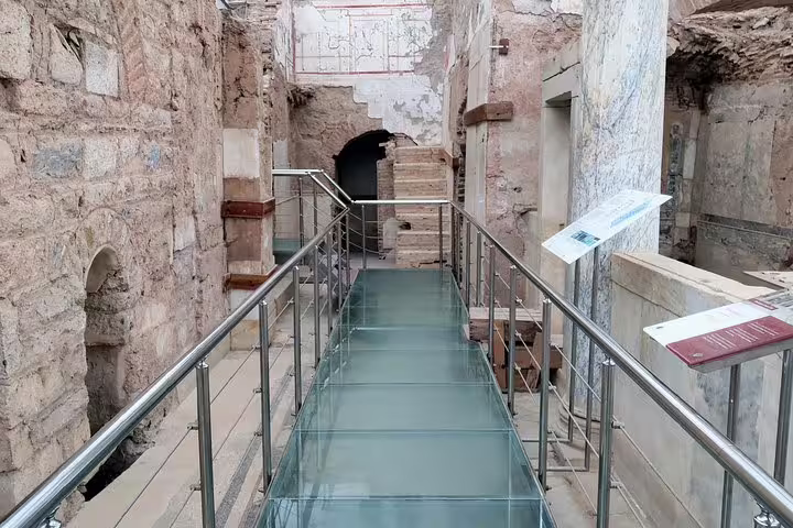 Glass walkway inside Ephesus Terrace Houses ruins on a private guided tour including Mary’s House, no hidden fees