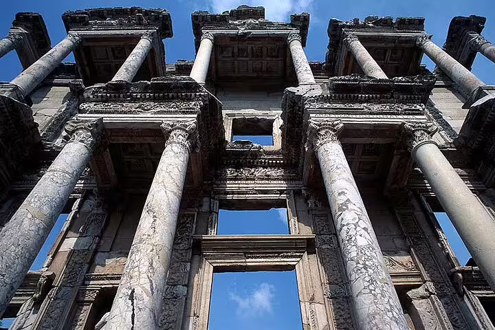 Explore the majestic ruins of Ephesus with its iconic ancient columns under a clear blue sky on this Turkish tour.