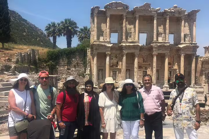 Tour group poses at the historic Celsus Library in Ephesus during Ephesus & Pamukkale day tour from Kusadasi.