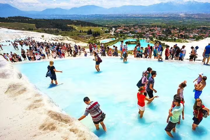 Visitors enjoy the thermal pools of Pamukkale with panoramic views, part of the 2-day Ephesus and Pamukkale tour.
