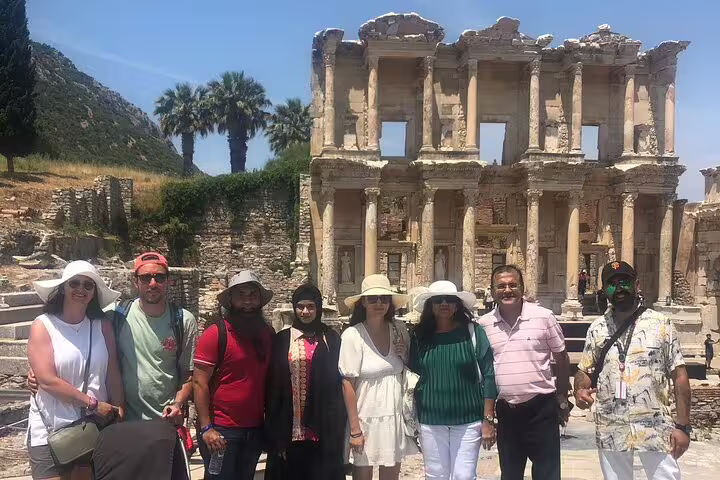 Visitors pose in front of the historic Celsus Library on a guided Ephesus private tour from Izmir Port.